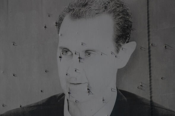 A mural of fallen Syrian President Bashar al-Assad ravaged by bullets 
