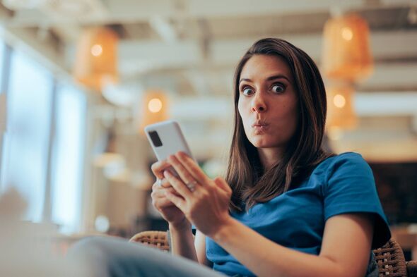 Surprised lady searching the internet waiting in an airport