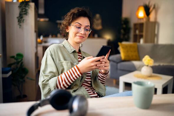 Young Caucasian woman texting messages on her phone.